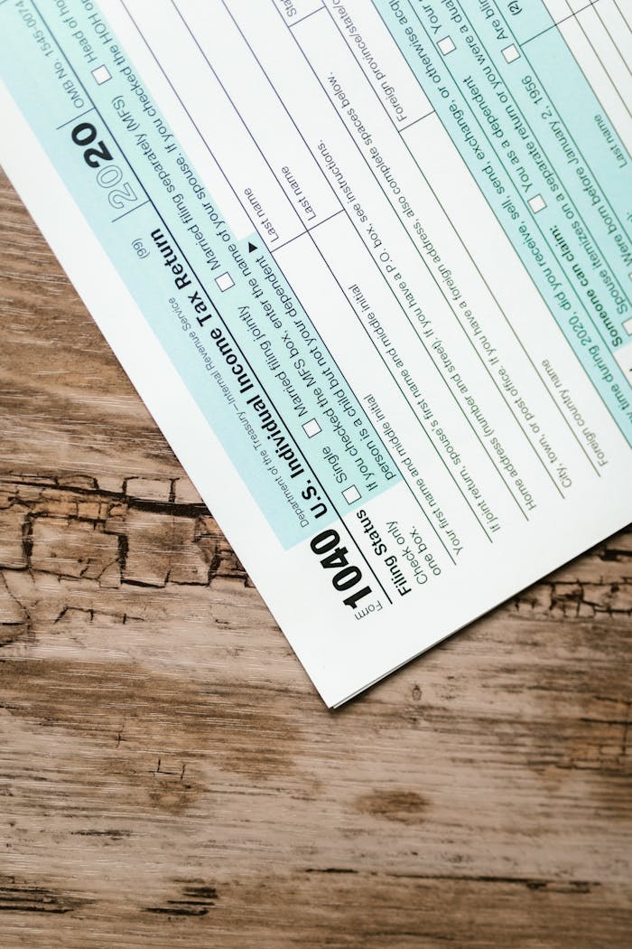 A close-up view of a 1040 US Individual Income Tax Return form on a wooden surface.